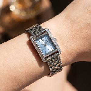 Close up shot of Michael Kors mko1169 on wrist showing light blue dial and silver-tone Roman numerals
