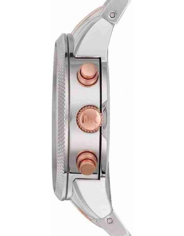 Close-up side view of a Michael Kors watch with a silver-toned metal case and rose gold-tone buttons and accents, featuring the embossed MK logo on the crown.