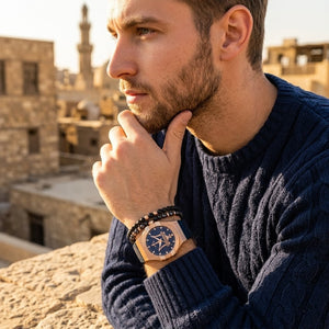 Elegant man wearing Maserati Potenza R8851108027 men's quartz battery watch with rose gold case and luxury blue dial