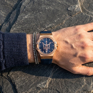 Close up of Maserati Potenza R8851108027 men's quartz battery watch on wrist showing blue textured dial and rose gold-tone case