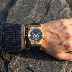 Close up of Maserati Potenza R8851108035 men's quartz battery watch on wrist showing blue dial and gold-tone case