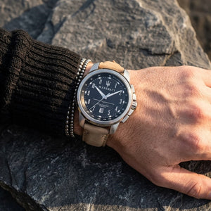 Close up of Maserati Successo R8851121004 men's quartz battery watch on wrist showing black racing dial and tan leather strap