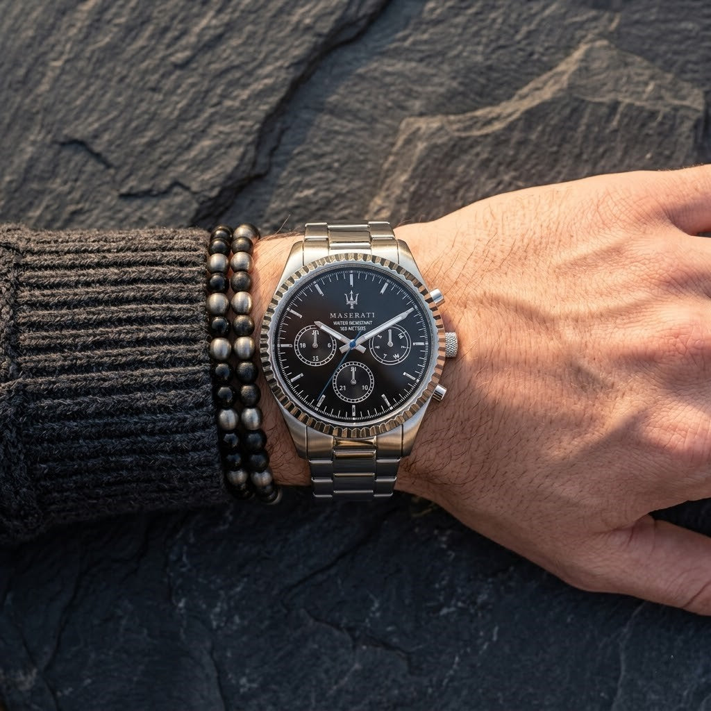 Close up of Maserati Competizione R8853100023 men's quartz battery watch on wrist showing black multi-function dial and silver metal bracelet