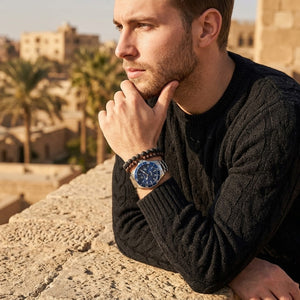 Elegant man wearing Maserati Competizione R8853100036 men's quartz battery watch with silver case and luxury blue dial