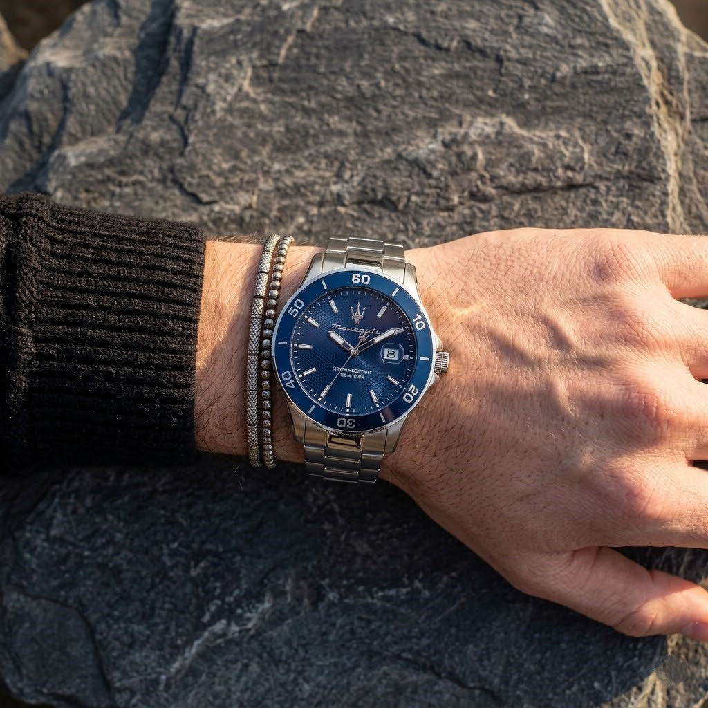 Close up of Maserati Competizione R8853100036 men's quartz battery watch on wrist showing blue honeycomb dial and silver metal bracelet