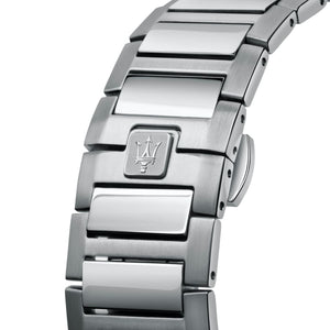 Close-up of a silver watch band with a brand logo