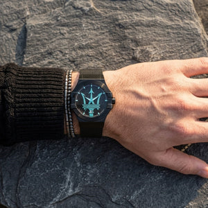 Close up of Maserati Potenza R8853144002 men's quartz battery watch on wrist showing Tiffany Blue logo and black mesh strap