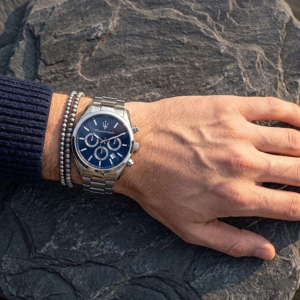 Close up of Maserati Attrazione R8853151005 men's quartz battery watch on wrist showing blue sunray dial and silver metal bracelet