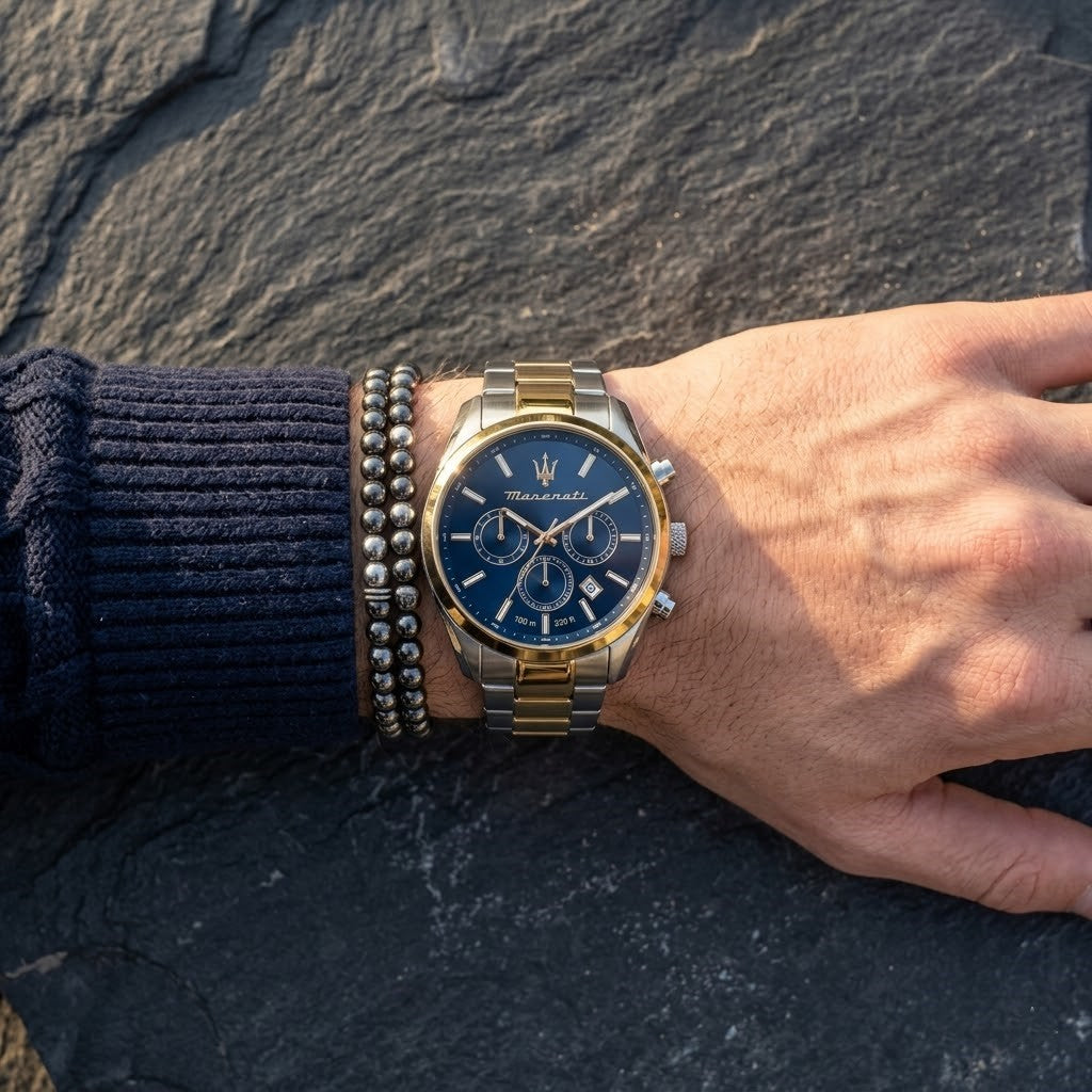 Close up of Maserati Attrazione R8853151008 men's quartz battery watch on wrist showing blue sunray dial and two-tone metal bracelet