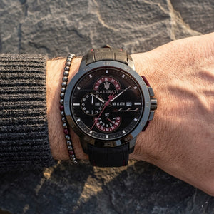 Close up of Maserati Ingegno R8871619003 men's quartz battery watch on wrist showing black layered dial and gunmetal-tone case