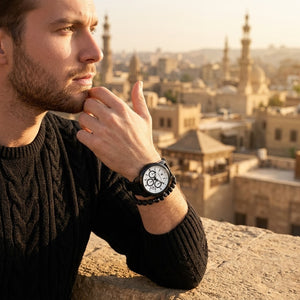 Elegant man wearing Maserati Successo R8871621010 men's quartz battery watch with black case and luxury white dial
