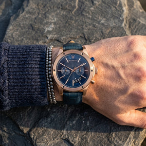 Close up of Maserati Circuito R8871627002 men's quartz battery watch on wrist showing blue textured dial and rose gold-tone case