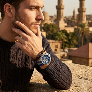 Elegant man wearing Maserati Royale R8871637001 men's quartz battery watch with silver-tone case and modern fabric strap