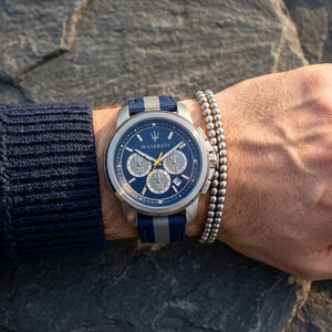 Close up of Maserati Royale R8871637001 men's quartz battery watch on wrist showing blue sunray dial and blue fabric strap