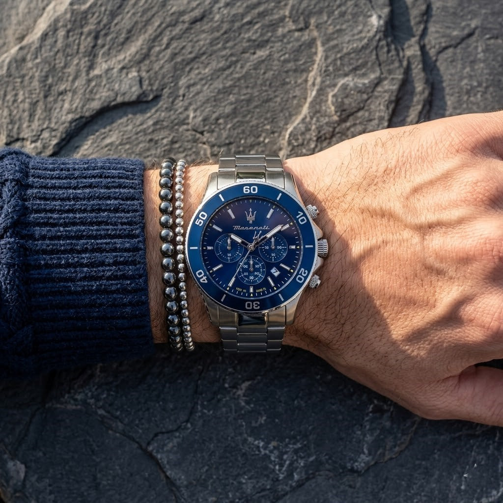 Close up of Maserati Competizione R8873600002 men's quartz battery watch on wrist showing blue chronograph dial and silver metal bracelet