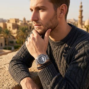 Elegant man wearing Maserati Traguardo R8873612008 men's quartz battery watch with silver case and luxury gray racing dial