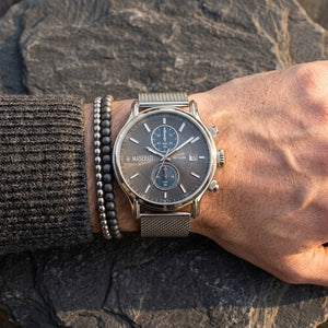 Close up of Maserati Epoca R8873618003 men's quartz battery watch on wrist showing gray sunray dial and silver mesh metal strap