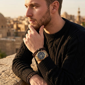 Elegant man wearing Maserati Epoca R8873618007 men's quartz battery watch with gold case and luxury black dial