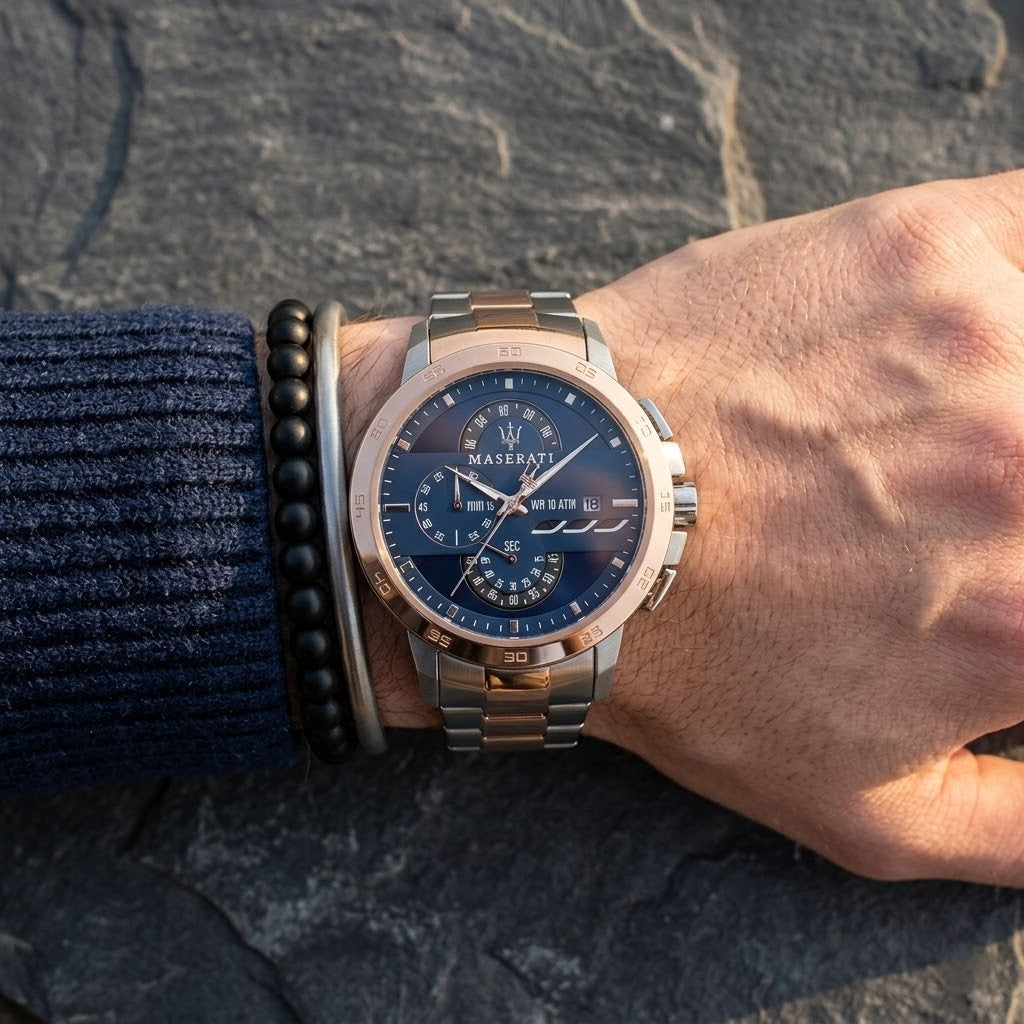 Close up of Maserati Ingegno R8873619002 men's quartz battery watch on wrist showing technical blue dial and two-tone metal bracelet