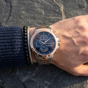 Close up of Maserati Ingegno R8873619002 men's quartz battery watch on wrist showing technical blue dial and two-tone metal bracelet