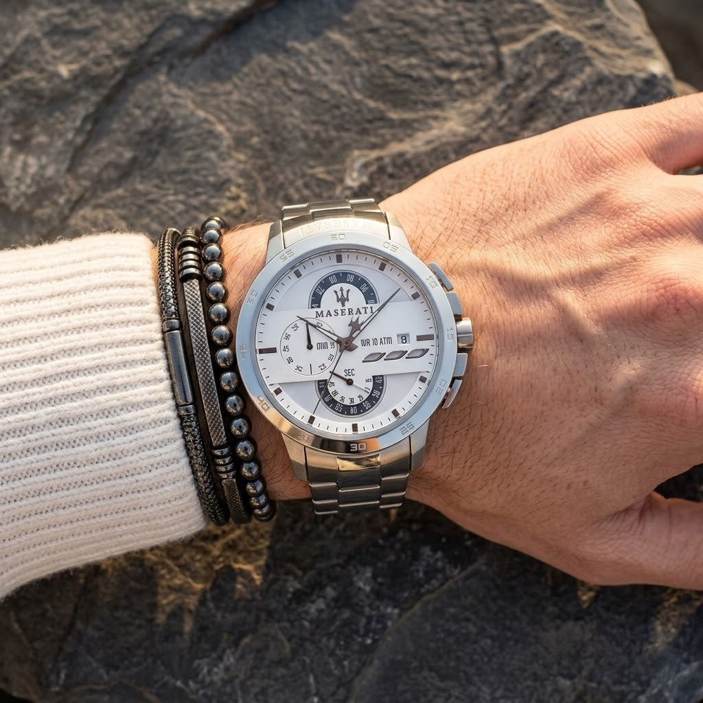 Close up of Maserati Ingegno R8873619004 men's quartz battery watch on wrist showing white technical dial and silver metal bracelet