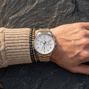 Close up of Maserati Sorpasso R8873624003 men's quartz battery watch on wrist showing white dial and two-tone metal bracelet