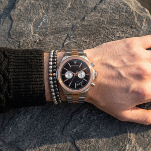 Close up of Maserati Circuito R8873627004 men's quartz battery watch on wrist showing black textured dial and two-tone rose gold metal bracelet