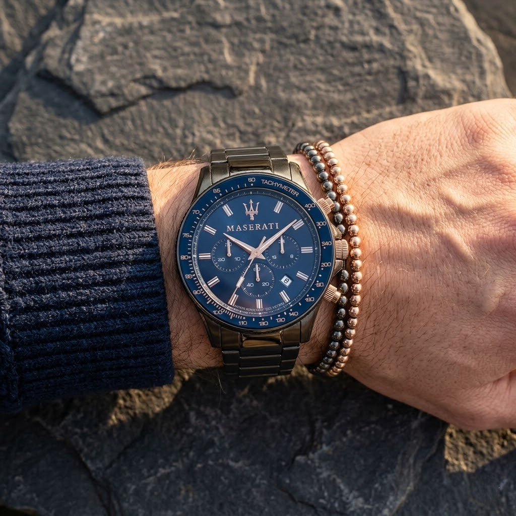 Close up of Maserati Sfida R8873640001 men's quartz battery watch on wrist showing blue sunray dial and gunmetal gray metal bracelet