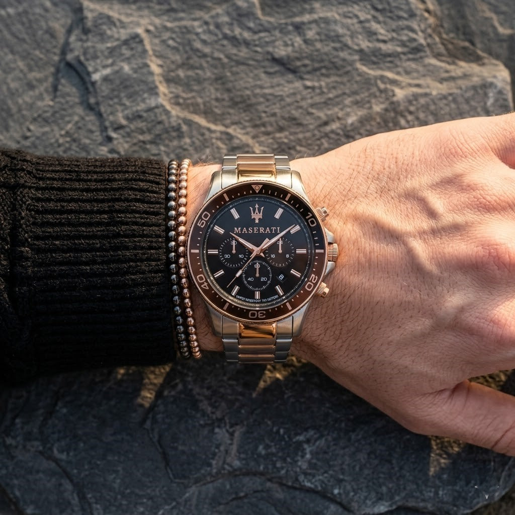 Close up of Maserati Sfida R8873640009 men's quartz battery watch on wrist showing black chronograph dial and two-tone metal bracelet