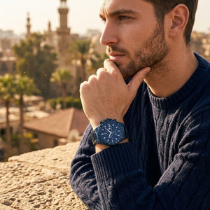 Elegant man wearing Maserati Sfida R8873640023 men's quartz battery watch with all-blue finish and racing style dial
