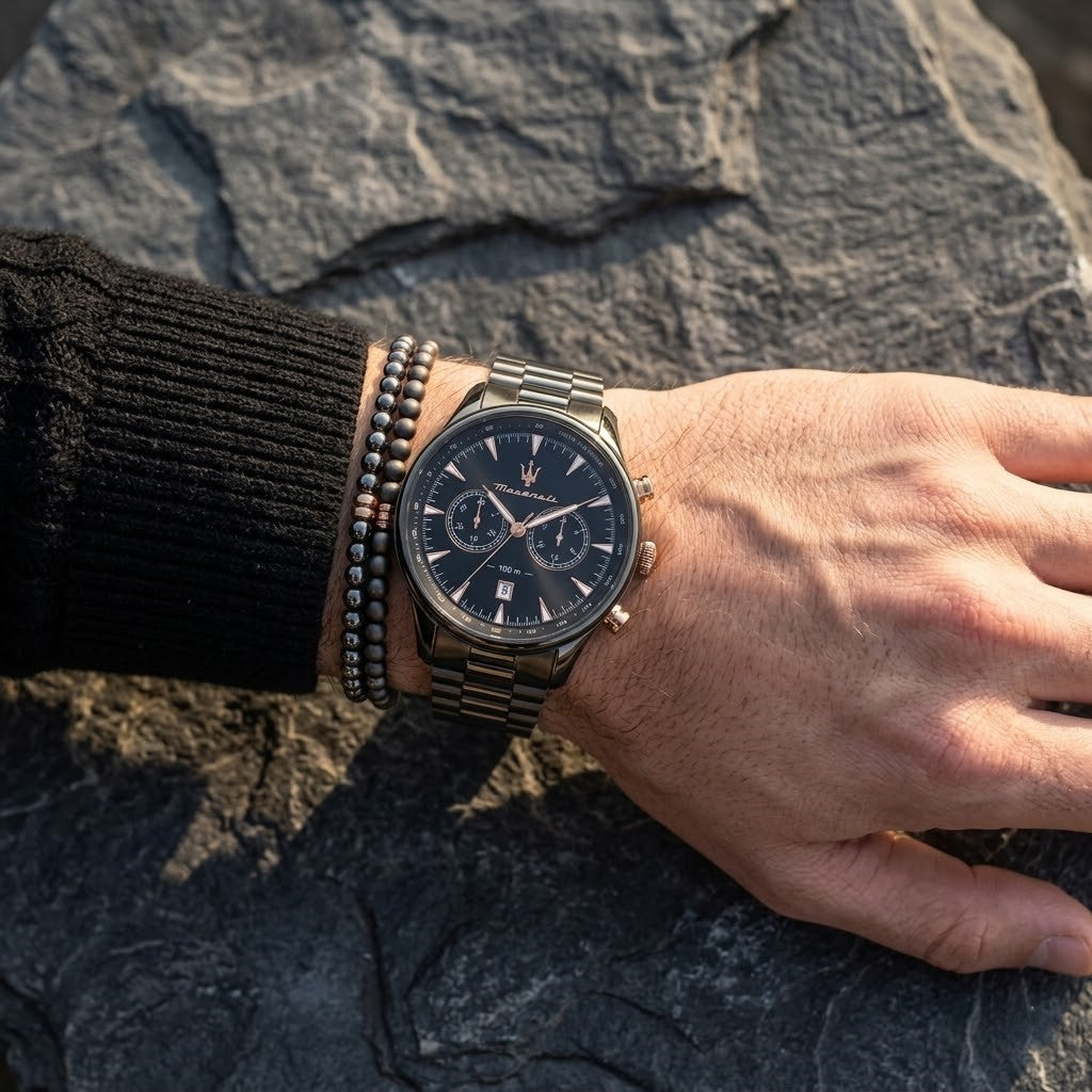 Close up of Maserati Traguardo R8873646001 men's quartz battery watch on wrist showing black chronograph dial and gunmetal grey metal bracelet