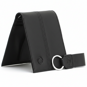 Side perspective of a standing Timberland black leather bifold wallet highlighting the vertical stitch lines and embossed brand logo next to its keychain