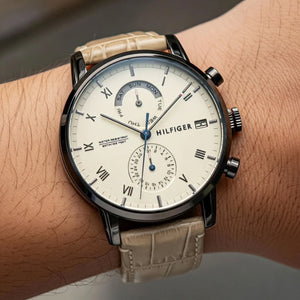 Close up shot of Tommy Hilfiger 1710399 watch on wrist showing the beige dial and roman numerals