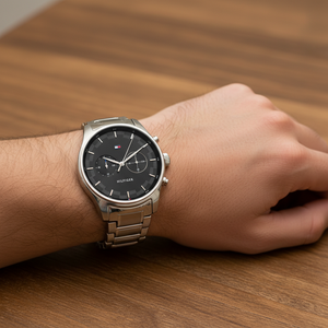 Close up shot of Tommy Hilfiger 1710419 watch on wrist showing the black sunray dial and silver case