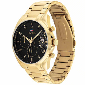 Angled view of Tommy Hilfiger 1710447 highlighting the polished gold-tone case and integrated stainless steel bracelet