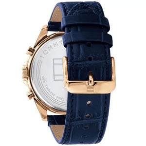 Left side perspective of the gold case and detailed stitching on the blue leather strap of the Tommy Hilfiger watch