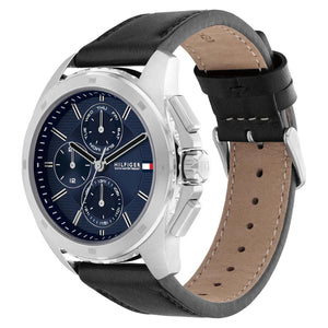 Left side perspective of the silver case and detailed stitching on the black leather strap of the Tommy Hilfiger watch
