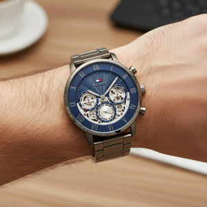 Close up shot of Tommy Hilfiger 1710707 watch on wrist showing the navy skeleton dial and Roman numerals