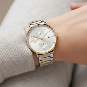 Close up shot of Tommy Hilfiger 1782299 watch on wrist showing the silver sunray dial and gold accents
