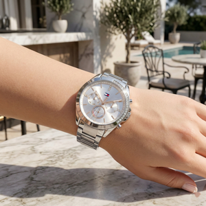 Close up shot of Tommy Hilfiger 1782384 on wrist showing the silver dial, rose gold sub-dial accents, and sparkling crystals