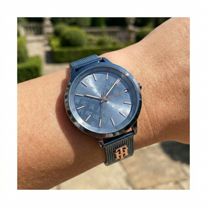 Close up shot of Tommy Hilfiger 1782589 on wrist showing the intricate TH monogram dial pattern and rose gold hands