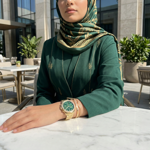 Woman wearing Tommy Hilfiger Ari gold and green watch for a luxurious evening and high-end professional look