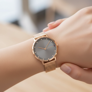 Close up shot of Tommy Hilfiger 1782669 watch on wrist showing the slim rose gold case and grey dial