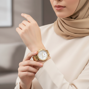 Female model wearing Tommy Hilfiger 1782703 gold watch with a glamorous evening outfit