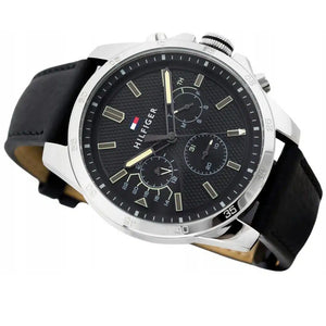 Angled view of Tommy Hilfiger 1791563 highlighting the polished silver case and durable black rubber strap