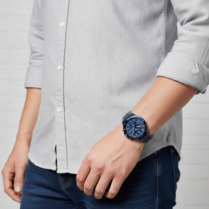 Man wearing Tommy Hilfiger Bank full blue metal watch for a dynamic, sporty, and bold everyday look