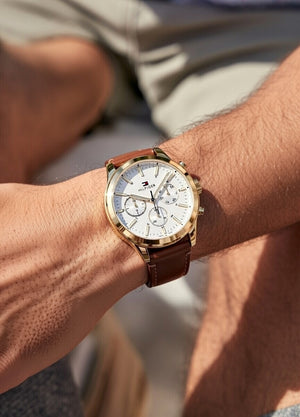 Male model wearing Tommy Hilfiger 1791742 gold watch with a formal suit