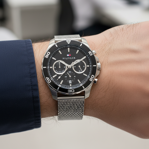 Close up shot of Tommy Hilfiger 1792092 watch on wrist showing the mesh texture and black bezel