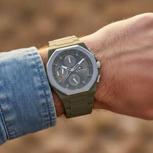 Close up shot of Tommy Hilfiger 1792121 watch on wrist showing the octagonal bezel and green dial