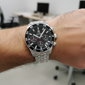 Close up macro view of the black dial, silver markers, and red hand details of Tommy Hilfiger 1792156